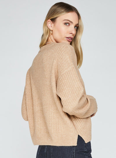 Woman wearing a cozy tan sweater for fall.